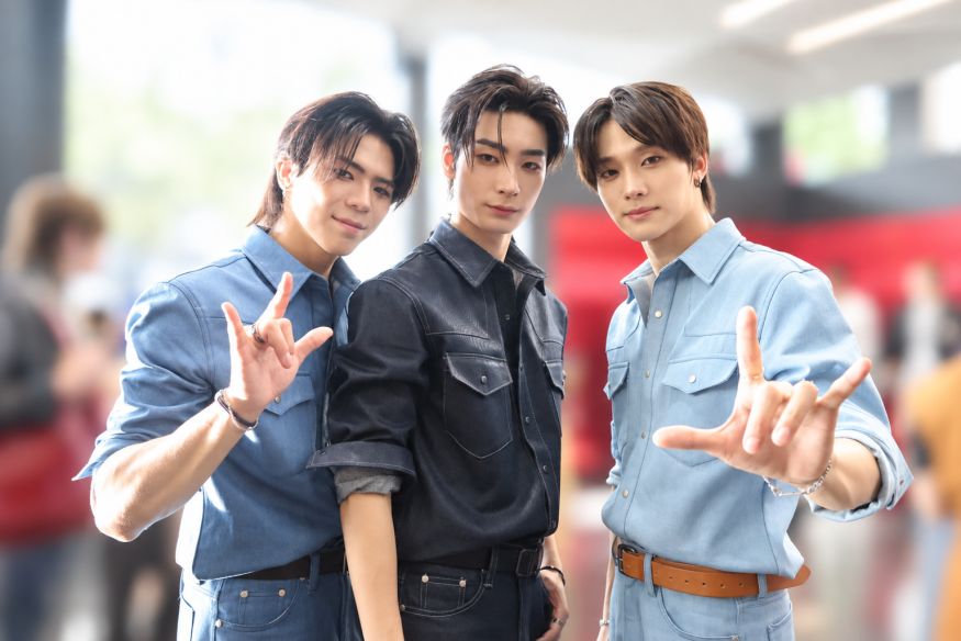 Big Ocean members pose hand gestures while